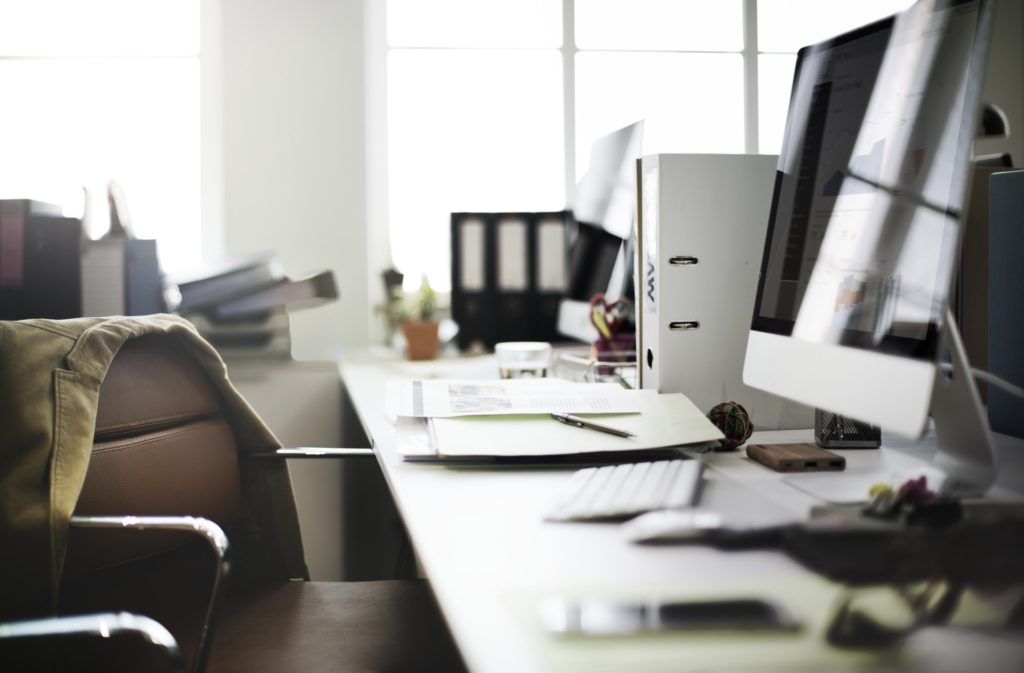 office desk with computer and papers