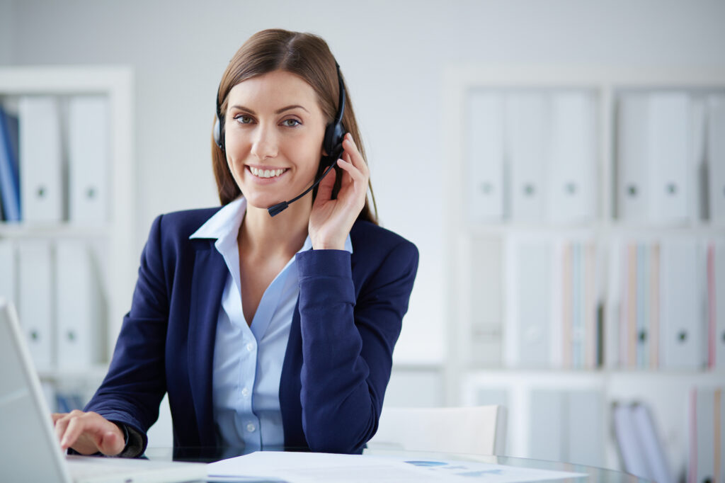 Young businesswoman with headset working in office