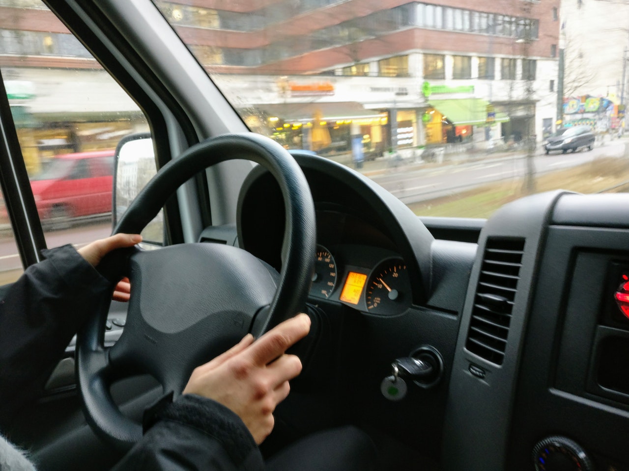 Man holding steering wheel in car